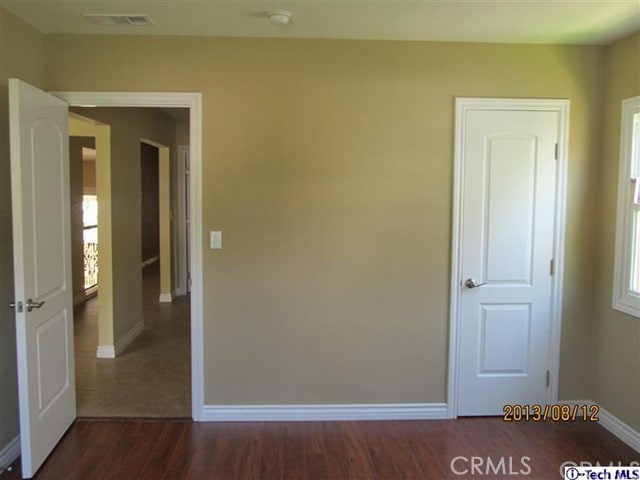 unfurnished bedroom featuring dark hardwood / wood-style flooring