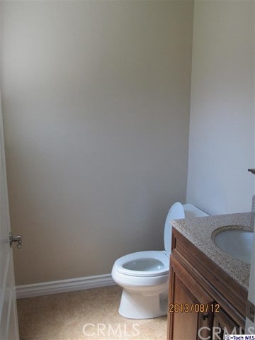 bathroom with vanity, toilet, and tile patterned flooring