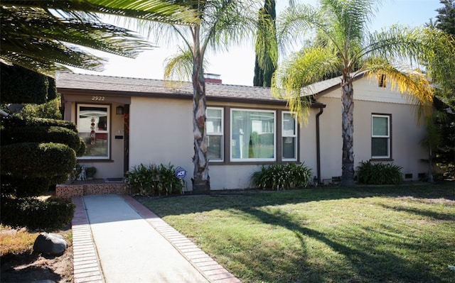 ranch-style home with a front lawn