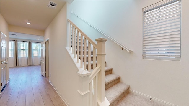 stairway featuring wood-type flooring