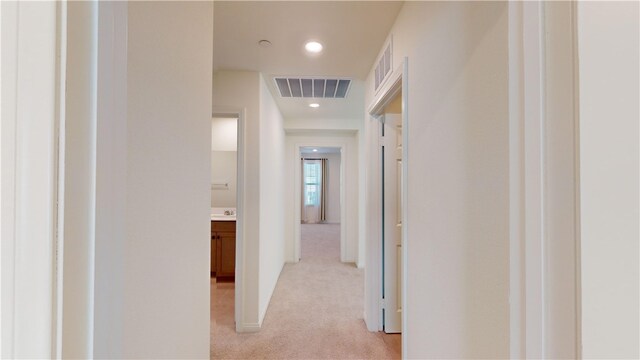 hallway featuring light carpet