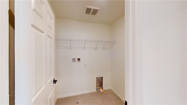 laundry area with hookup for a washing machine and light tile patterned flooring