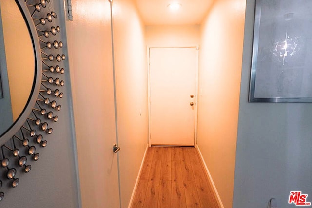 corridor with light wood-type flooring