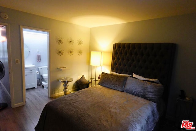 bedroom with hardwood / wood-style flooring and ensuite bathroom