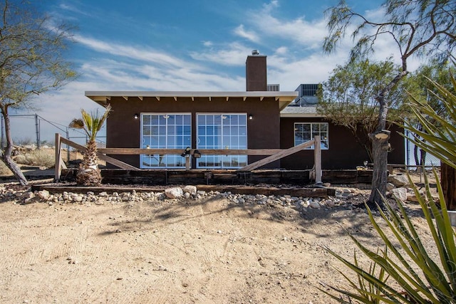 rear view of house with central AC unit