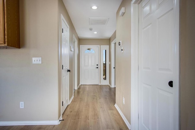 hallway with light hardwood / wood-style flooring