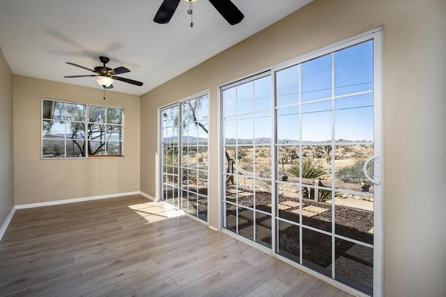 interior space with ceiling fan