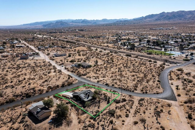 birds eye view of property with a mountain view