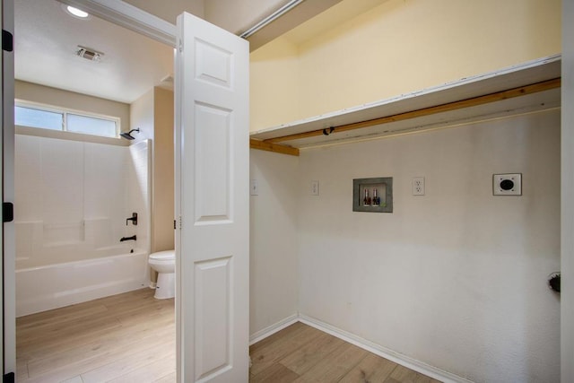 laundry area with hookup for a washing machine, light hardwood / wood-style flooring, and hookup for an electric dryer