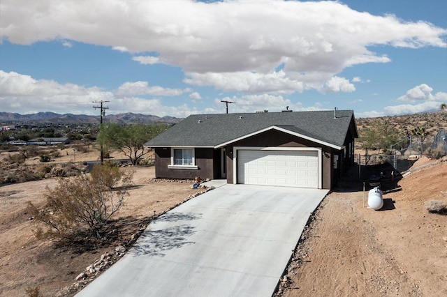 ranch-style home with a mountain view and a garage