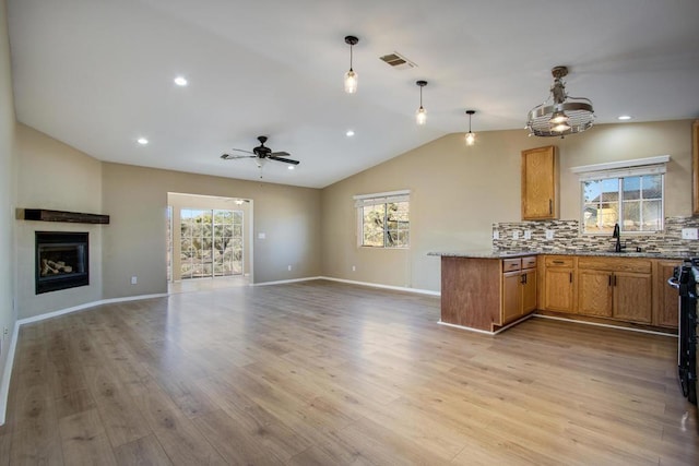 kitchen with pendant lighting, ceiling fan, light hardwood / wood-style flooring, and a healthy amount of sunlight