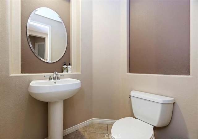 bathroom with tile patterned floors, toilet, and sink