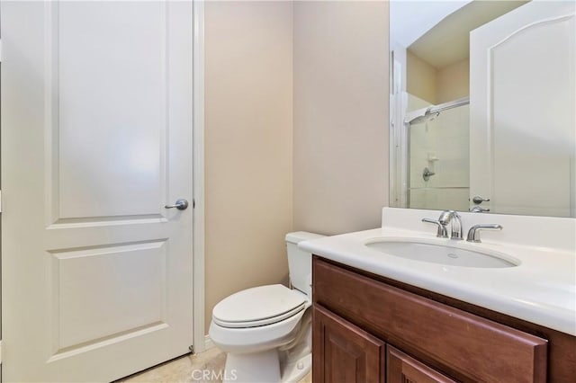 bathroom featuring vanity, toilet, and a shower with shower door