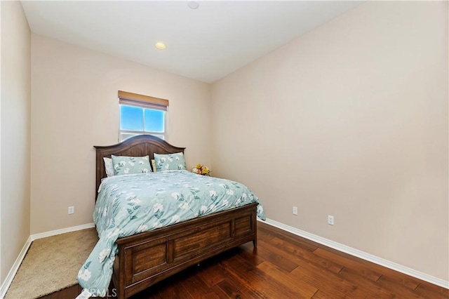 bedroom with dark wood-type flooring