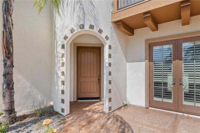 entrance to property with a patio area and french doors