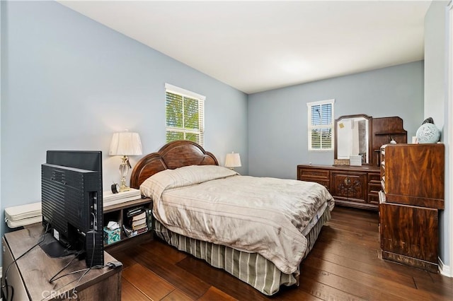 bedroom with dark hardwood / wood-style flooring