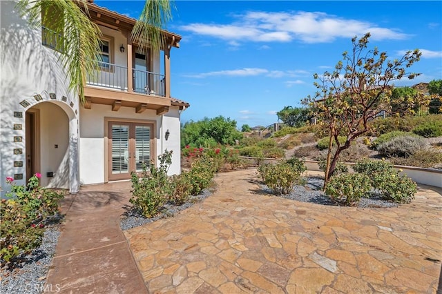 exterior space featuring french doors and a balcony