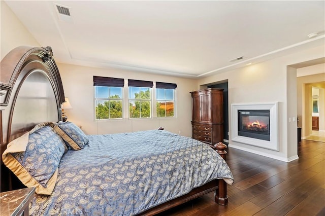 bedroom with dark hardwood / wood-style floors