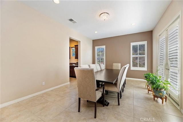 tiled dining space with a healthy amount of sunlight