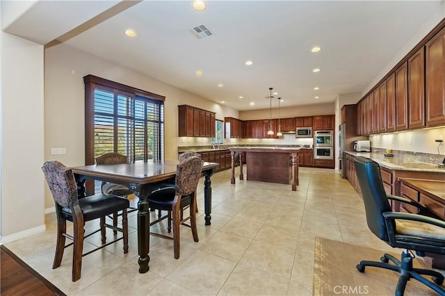 dining room with sink and light tile patterned floors