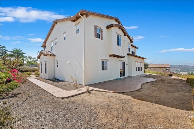 back of house with a patio