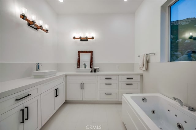 bathroom with vanity and a washtub