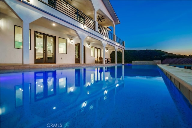 view of pool at dusk