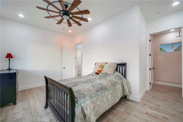 bedroom with light hardwood / wood-style flooring and ceiling fan