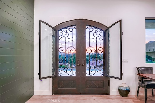 entrance foyer featuring french doors and hardwood / wood-style flooring