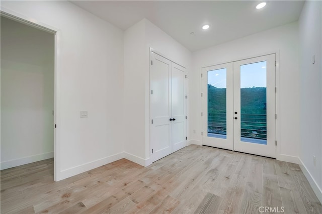 doorway to outside with french doors and light hardwood / wood-style floors