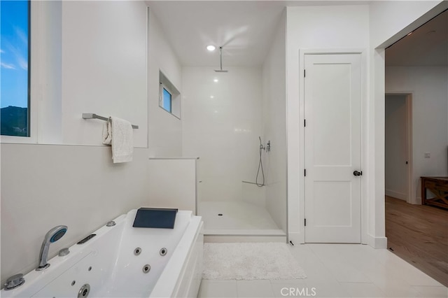 bathroom featuring separate shower and tub and hardwood / wood-style flooring