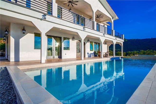 view of swimming pool with a patio and ceiling fan