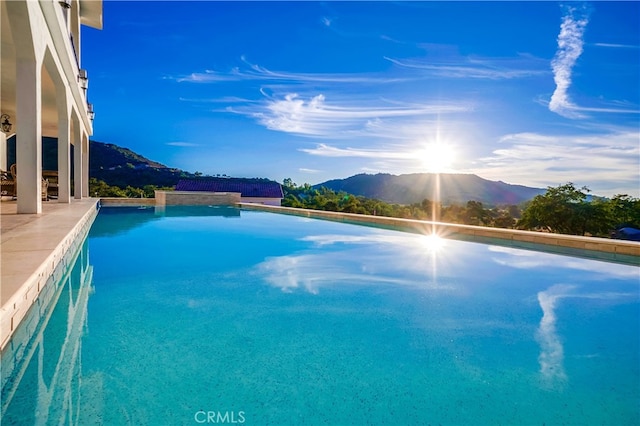 view of swimming pool with a mountain view