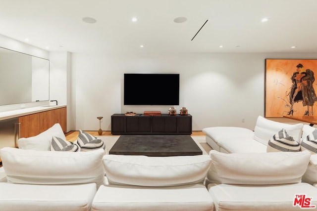 living room featuring sink and light hardwood / wood-style floors