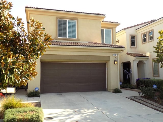 mediterranean / spanish-style house with a garage