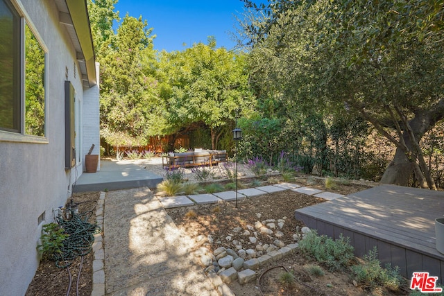 view of yard with a patio and a deck