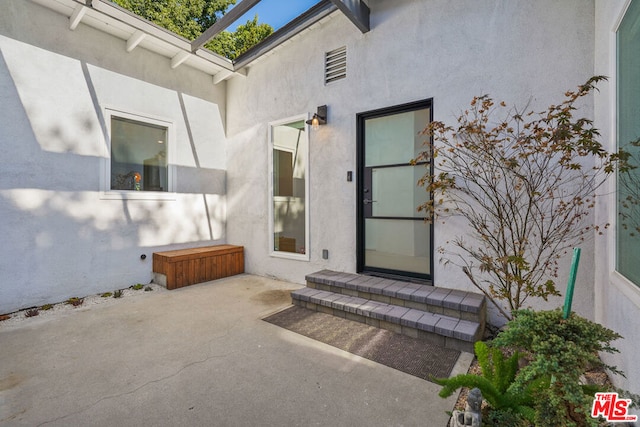 doorway to property with a patio area