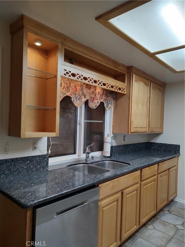 kitchen with stainless steel dishwasher, sink, and light brown cabinetry