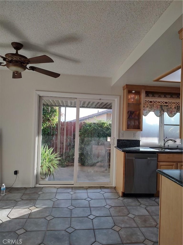 kitchen featuring a textured ceiling, dishwasher, ceiling fan, and sink