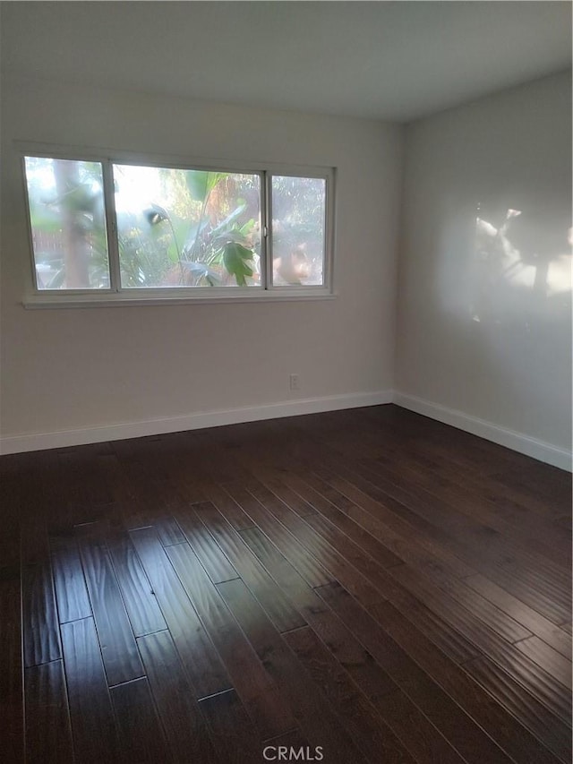 spare room with dark hardwood / wood-style floors