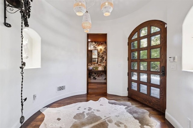 foyer with dark hardwood / wood-style flooring and french doors