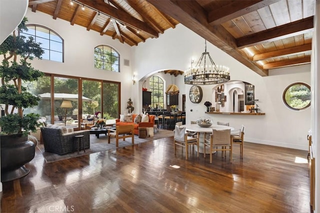 dining room with beamed ceiling, wooden ceiling, and hardwood / wood-style flooring