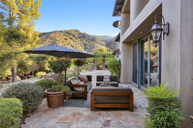 view of patio / terrace with a mountain view and an outdoor hangout area