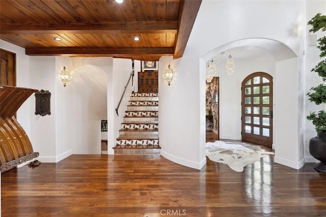 entryway featuring beam ceiling, dark hardwood / wood-style flooring, french doors, and wooden ceiling