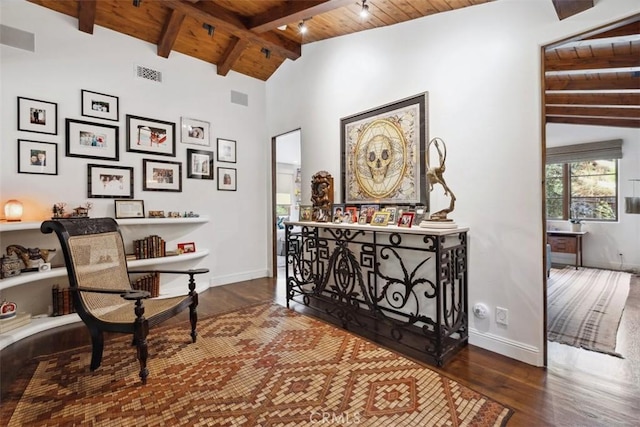 sitting room featuring vaulted ceiling with beams, wooden ceiling, and dark hardwood / wood-style floors