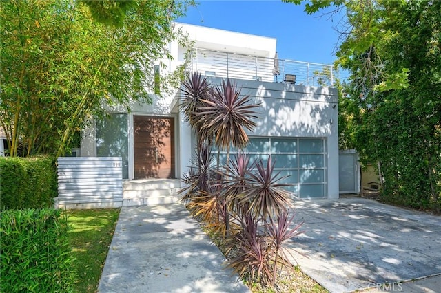 view of front of house featuring a garage and concrete driveway