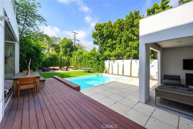 view of pool with a fenced in pool, a patio area, fence, a deck, and an outdoor living space