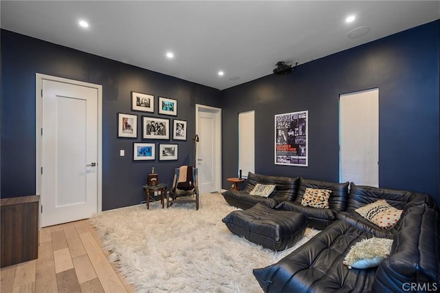 living room with light wood-style flooring and recessed lighting