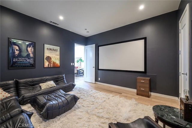 home theater room featuring recessed lighting, wood finished floors, visible vents, and baseboards