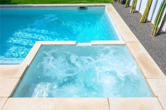 view of swimming pool featuring a pool with connected hot tub